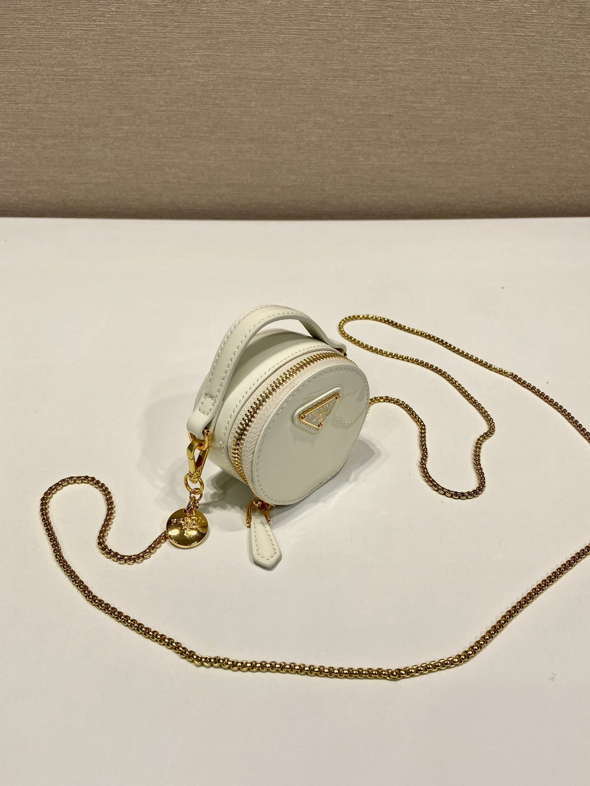 MINI ROUND BAG 8 IN WHITE GLOSSY CALFSKIN GOLD HARDWARE