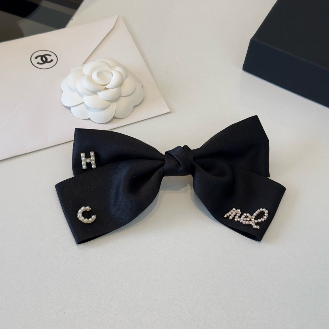 CHANEL 26S BOW HAIR CLIP IN BLACK SATIN 503134