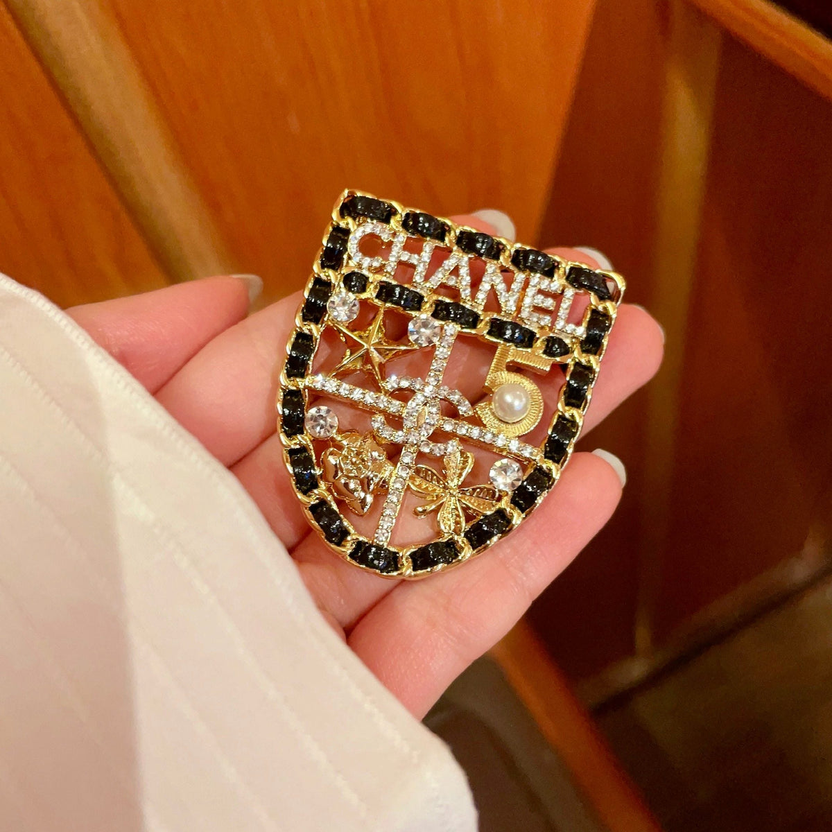 CHANEL 26S NUMBER SHIELD BROOCH WITH MULTI-CRYSTAL DETAIL IN GOLD METAL 631042