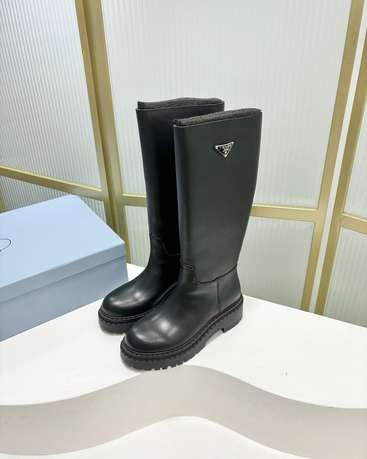 KNEE BOOTS WITH TRIANGLE LOGO IN BLACK CALFSKIN