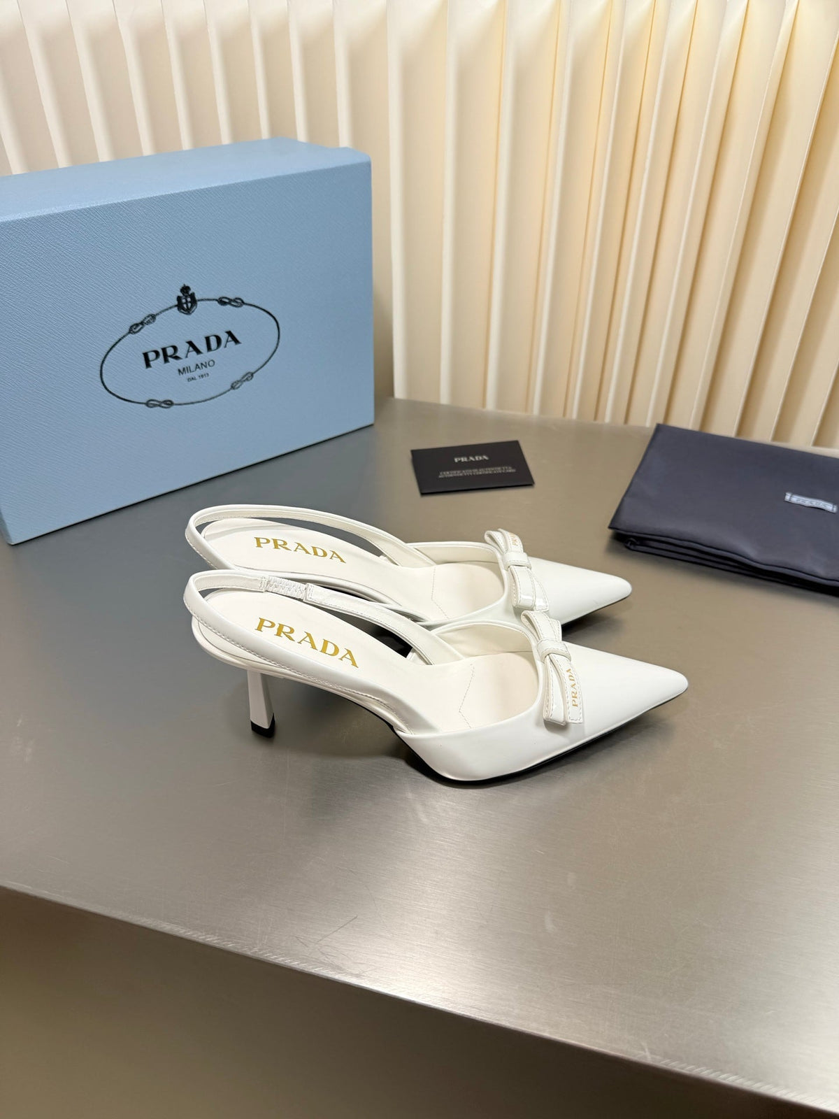PRADA 26S POINTED-TOE SLINGBACK PUMPS IN WHITE PATENT CALFSKIN WITH BOW