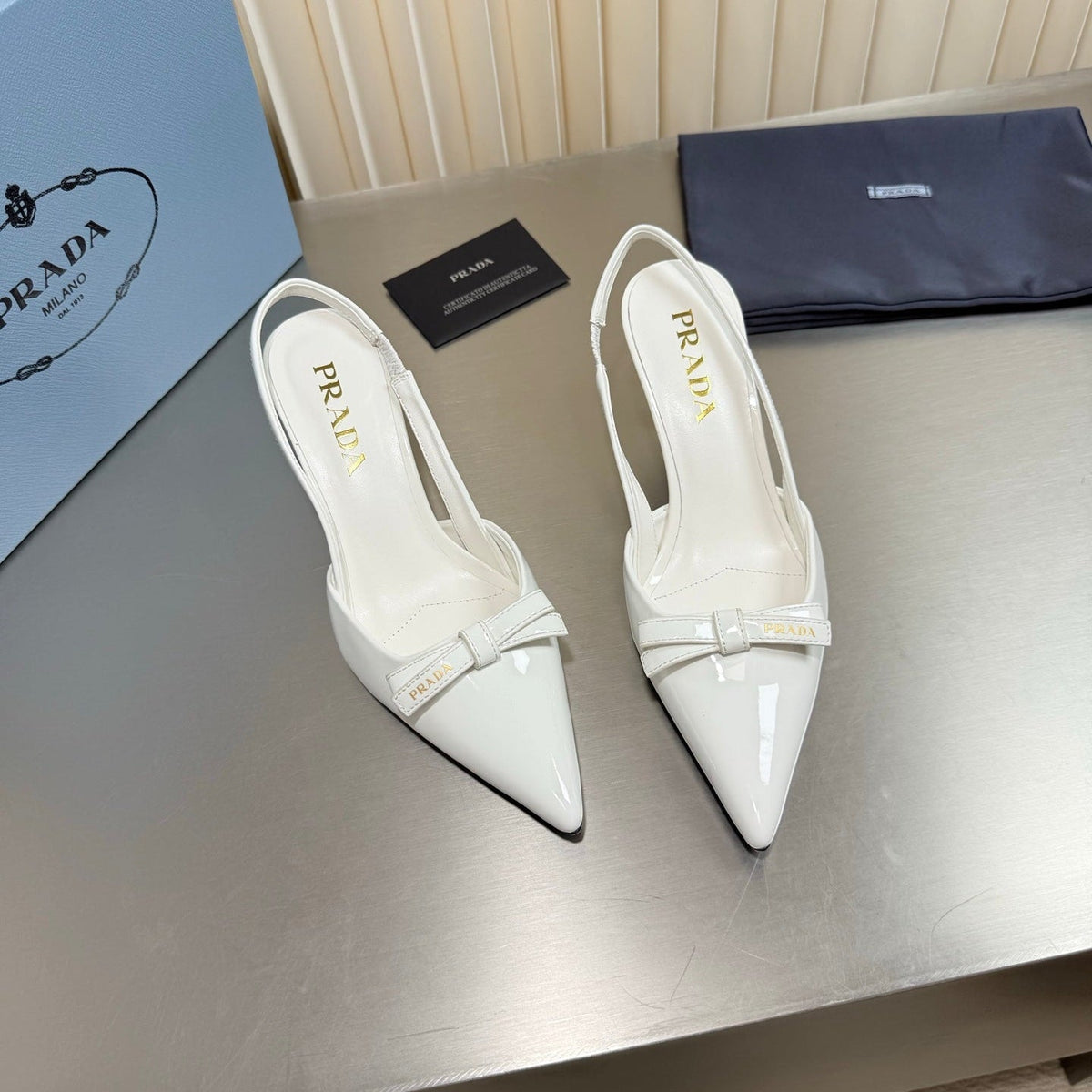 PRADA 26S POINTED-TOE SLINGBACK PUMPS IN WHITE PATENT CALFSKIN WITH BOW
