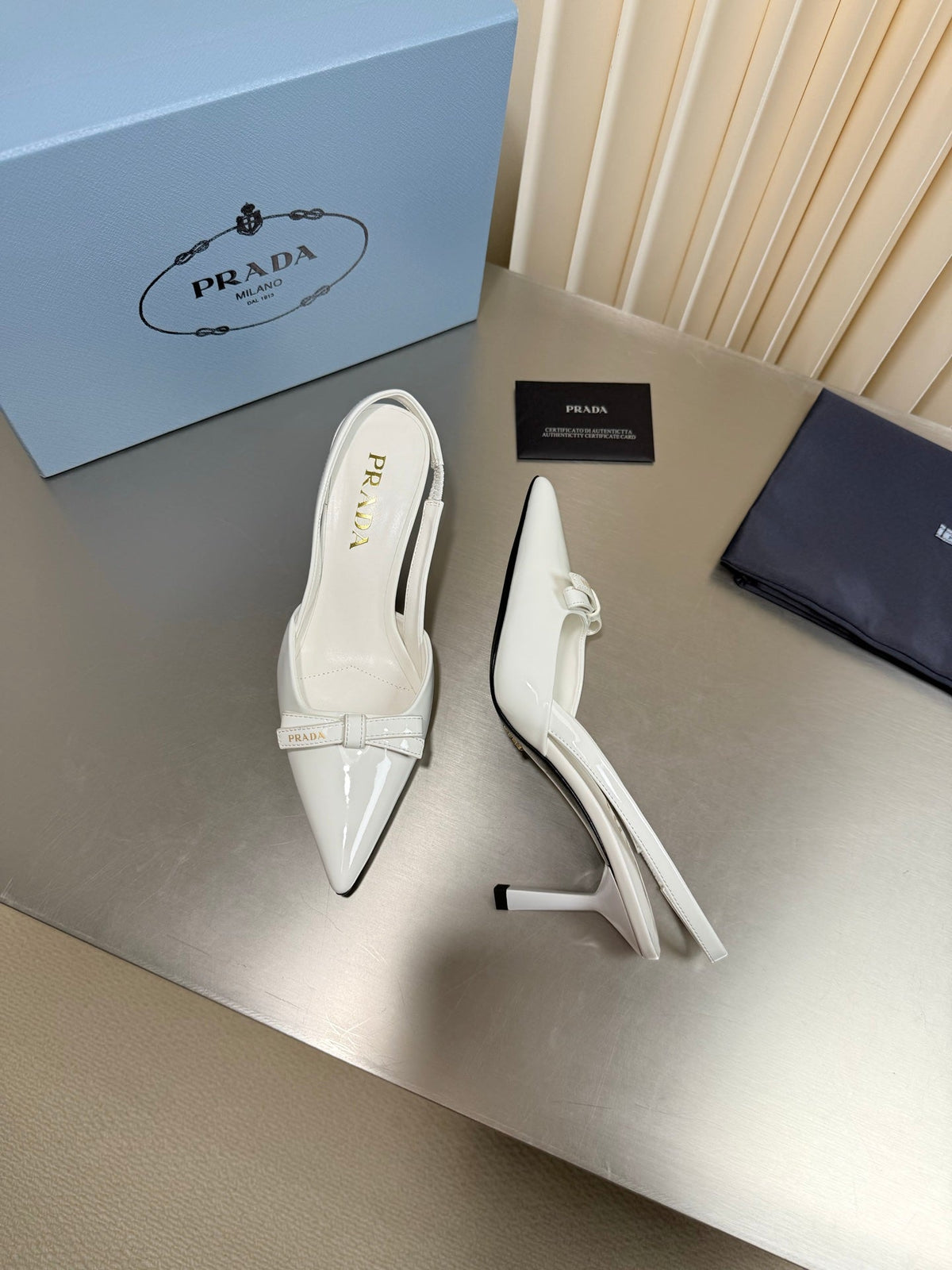 PRADA 26S POINTED-TOE SLINGBACK PUMPS IN WHITE PATENT CALFSKIN WITH BOW