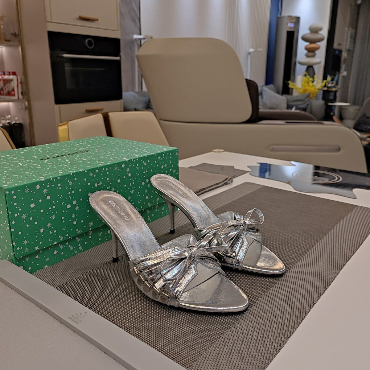 BOW-EMBELLISHED HIGH MULES IN SILVER METALLIC SHEEPSKIN