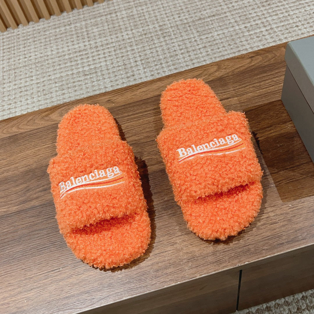 FURRY SLIDES IN ORANGE CURLY SHEARLING