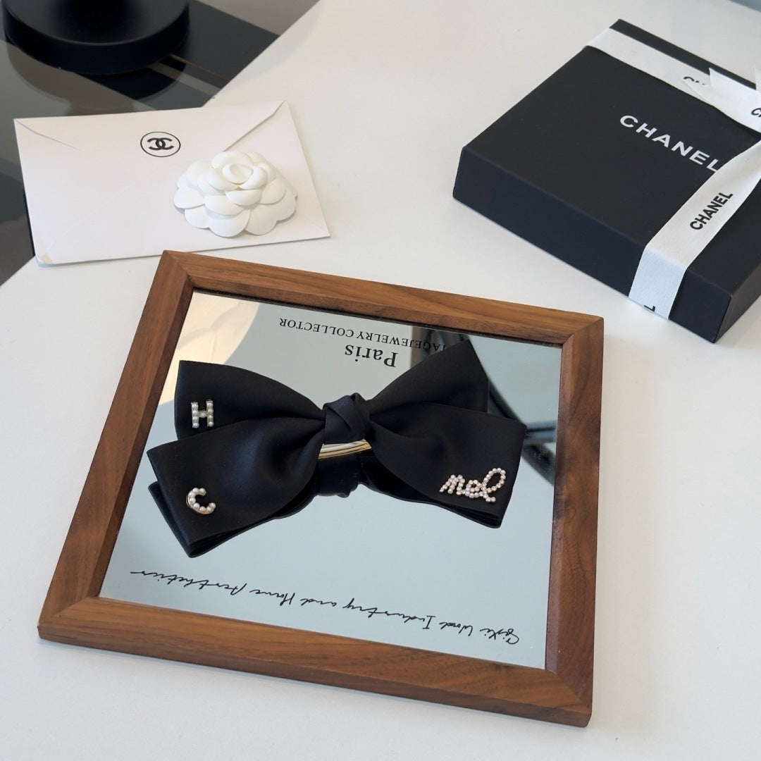 CHANEL 26S BOW HAIR CLIP IN BLACK SATIN 503134