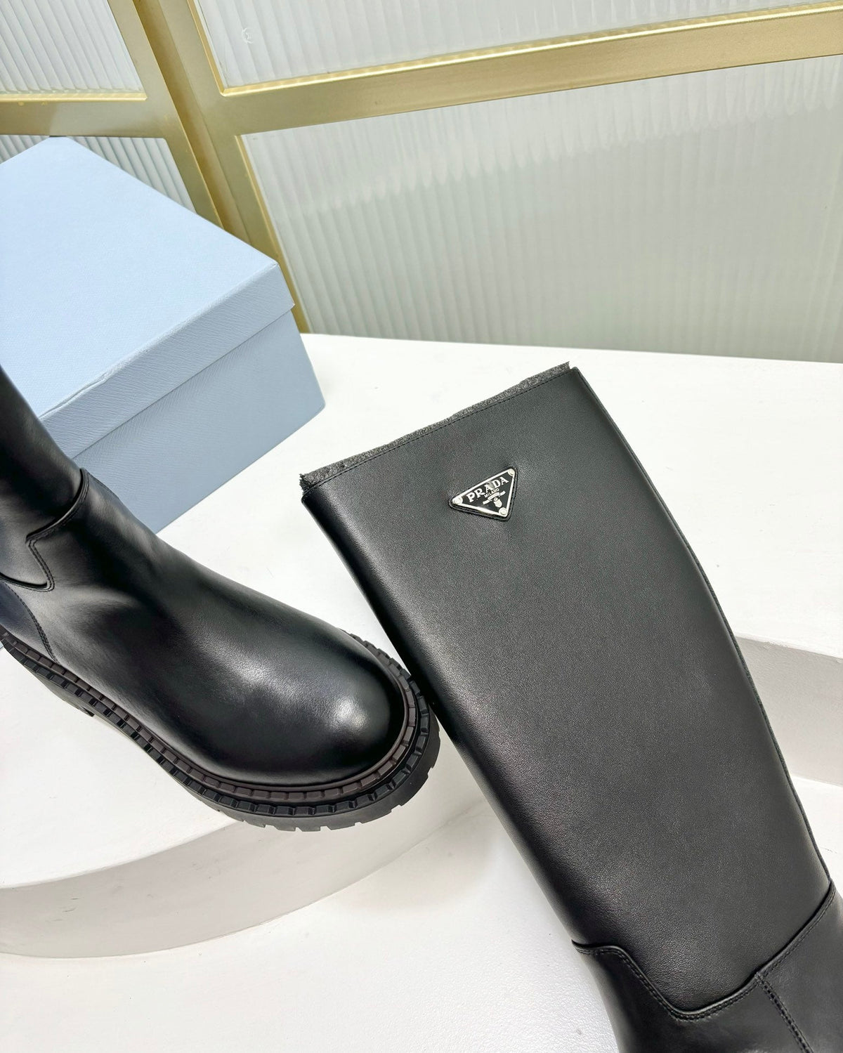 KNEE BOOTS WITH TRIANGLE LOGO IN BLACK CALFSKIN