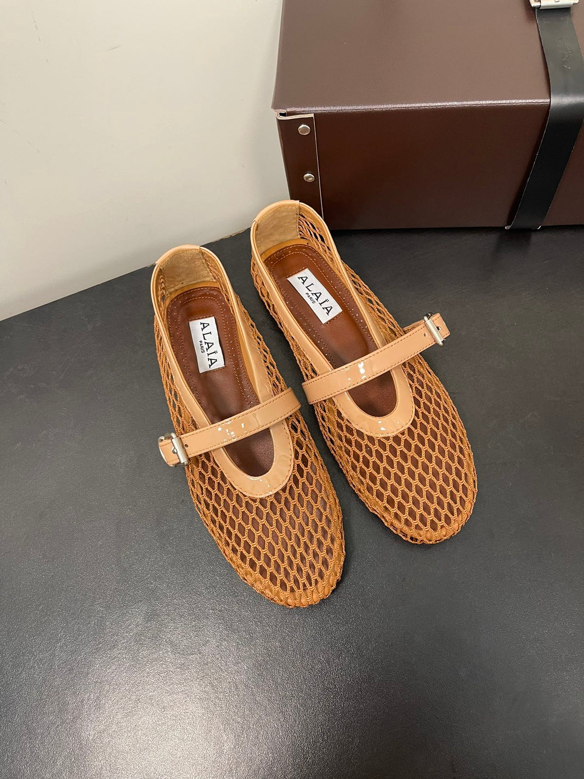 ALAIA BALLET FLATS IN COPPER BROWN MESH FISHNET
